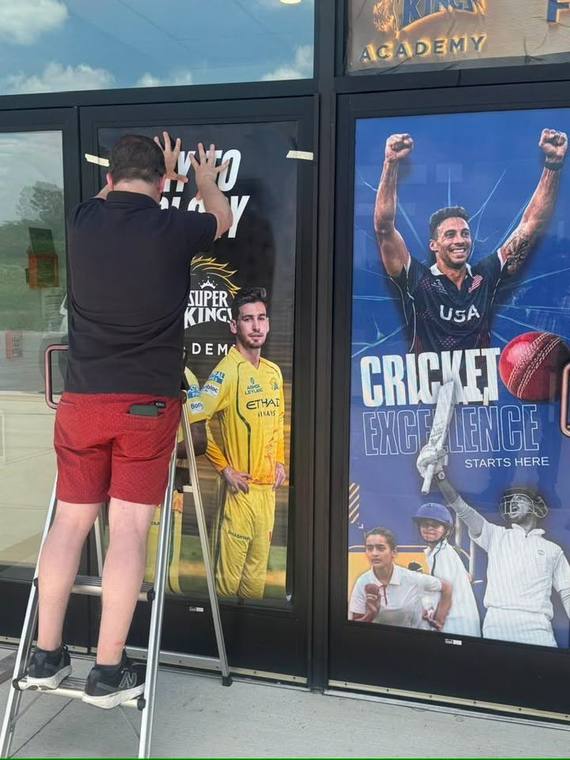 Window decal being installed on a storefront
